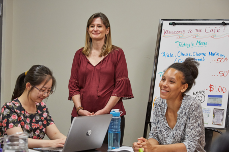 Tina Moffat facilitates a group discussion with two women