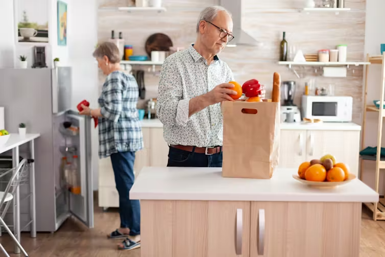 An older couple in the kitchen.