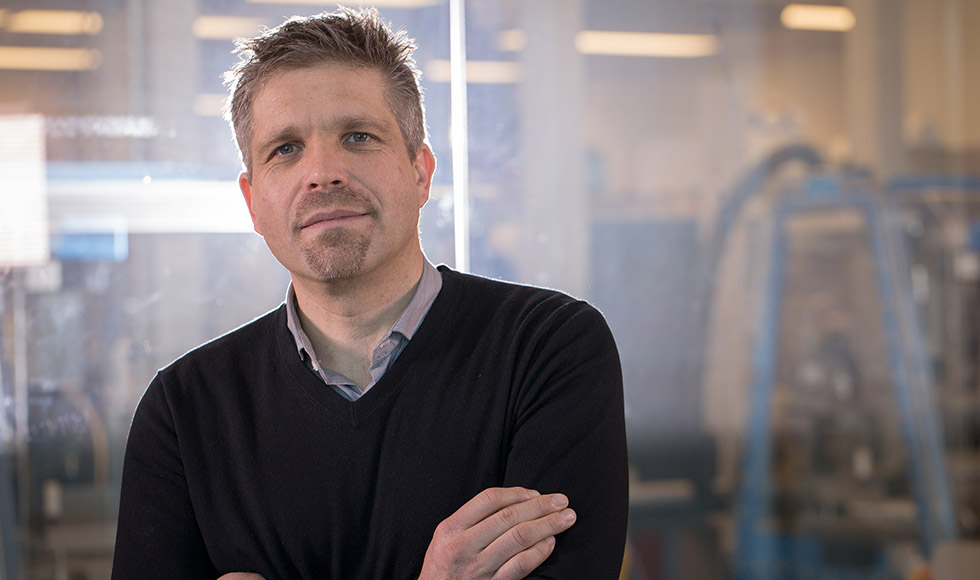 Hendrik Poinar with his arms crossed looking directly at the camera