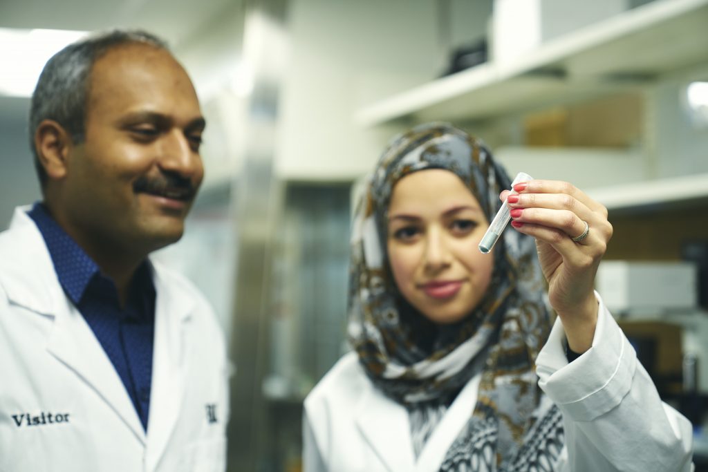 Ravi Selvaganapathy and Rana Attalla in a McMaster lab looking at a test tube