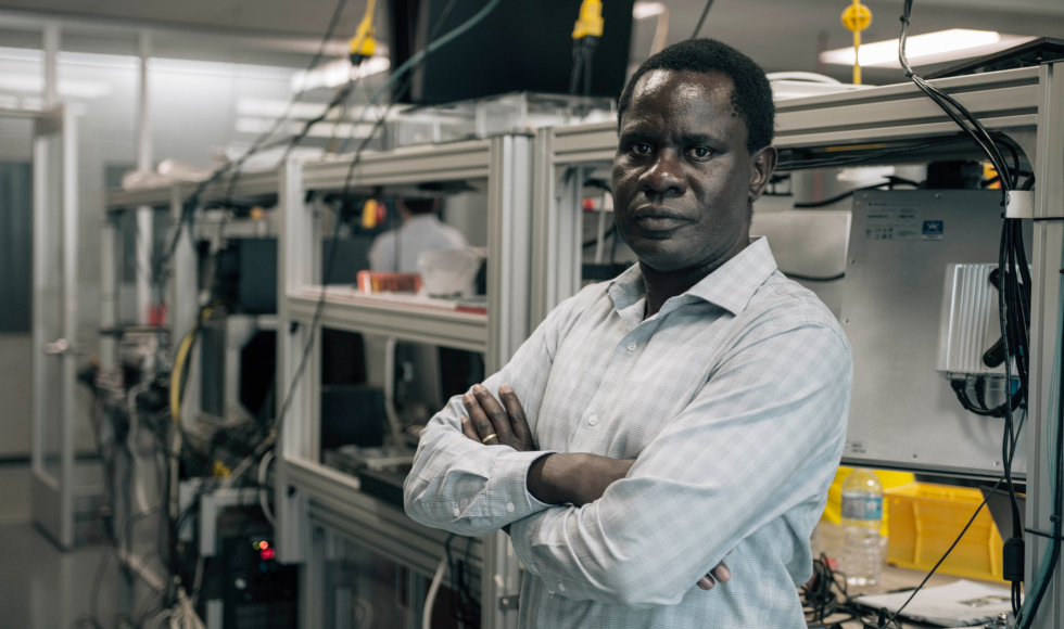 Man standing in McMaster engineering lab with his arms crossed