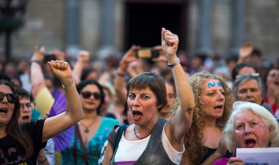 Women protesting, holding their fists in the air