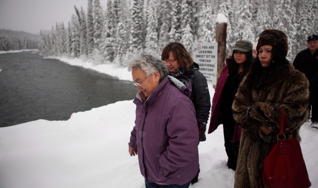 Supporters of the Unist'ot'en camp and Wet'suwet'en walk along a bridge over the Wedzin kwa River leading towards the main camp outside Houston, B.C., on Jan. 9, 2019. THE CANADIAN PRESS/Chad Hipolito