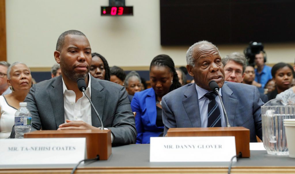 Author Ta-Nehisi Coates and actor Danny Glover sit side by side at a at a table to testify during a hearing before the House Judiciary Subcommittee on Capitol Hill on June 19, 2019.