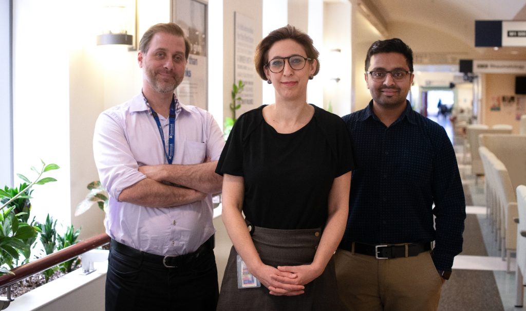 three researchers standing together.