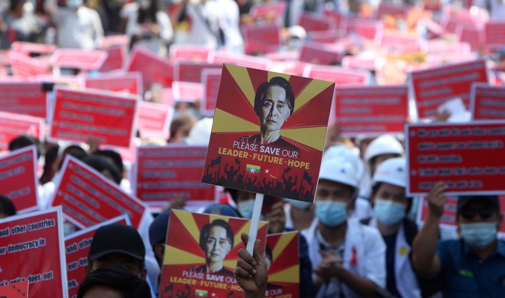 A protester holds up a placard with an image of deposed Myanmar leader Aung San Suu Kyi during an anti-coup rally in Mandalay, Myanmar, on Feb. 15, 2021. (AP Photo)