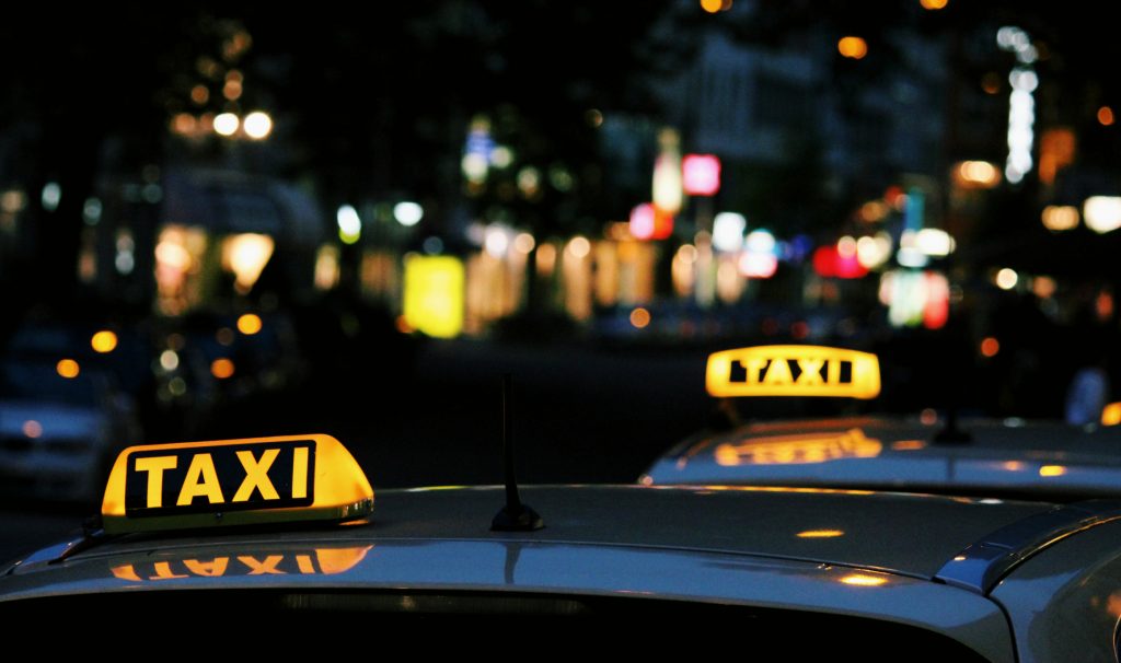 Lit-up taxi signs at night