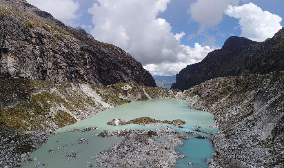 Aerial shot of glacier and hills around it.