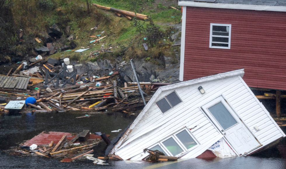 A trail of destruction left by Hurricane Fiona that includes buildings floating in water