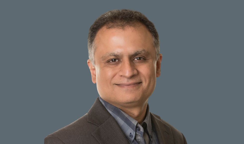 Headshot of Waliul Khan against a grey background.