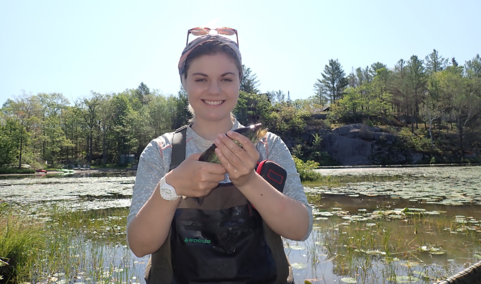 Image of someone holding a fish in their hands and smiling