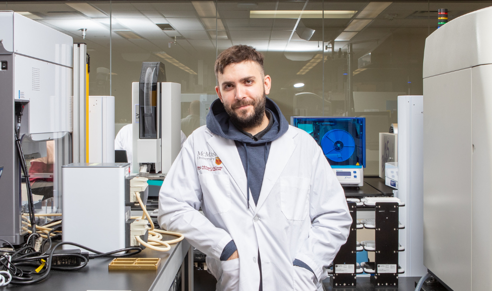 Jonathan Stokes in a white lab coat looking directly at the camera