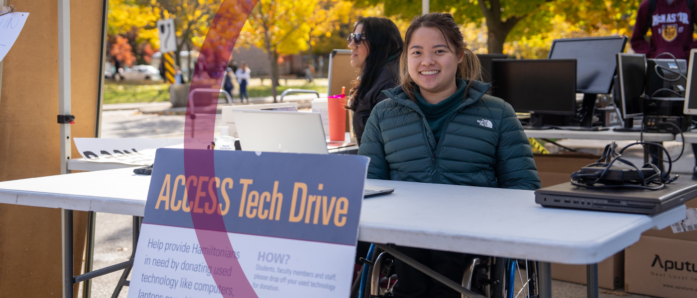 A student poses for the camera at an Access Tech booth.