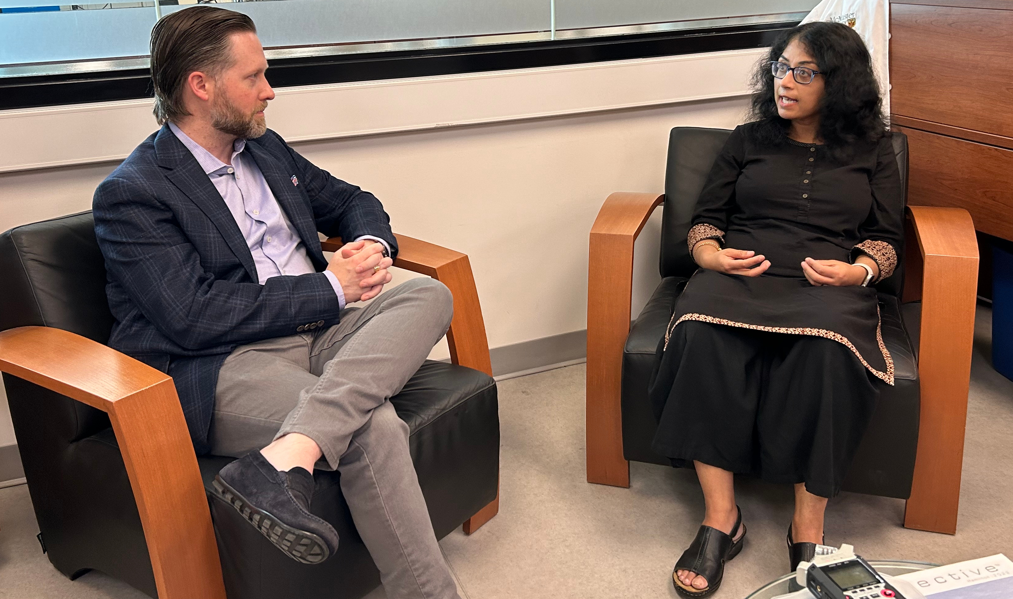 Matthew Miller and Chandrima Chakraborty sitting in chairs, chatting.