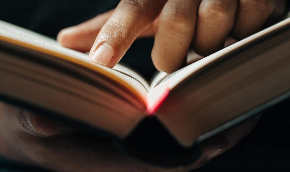 A closeup of hands holding an open book